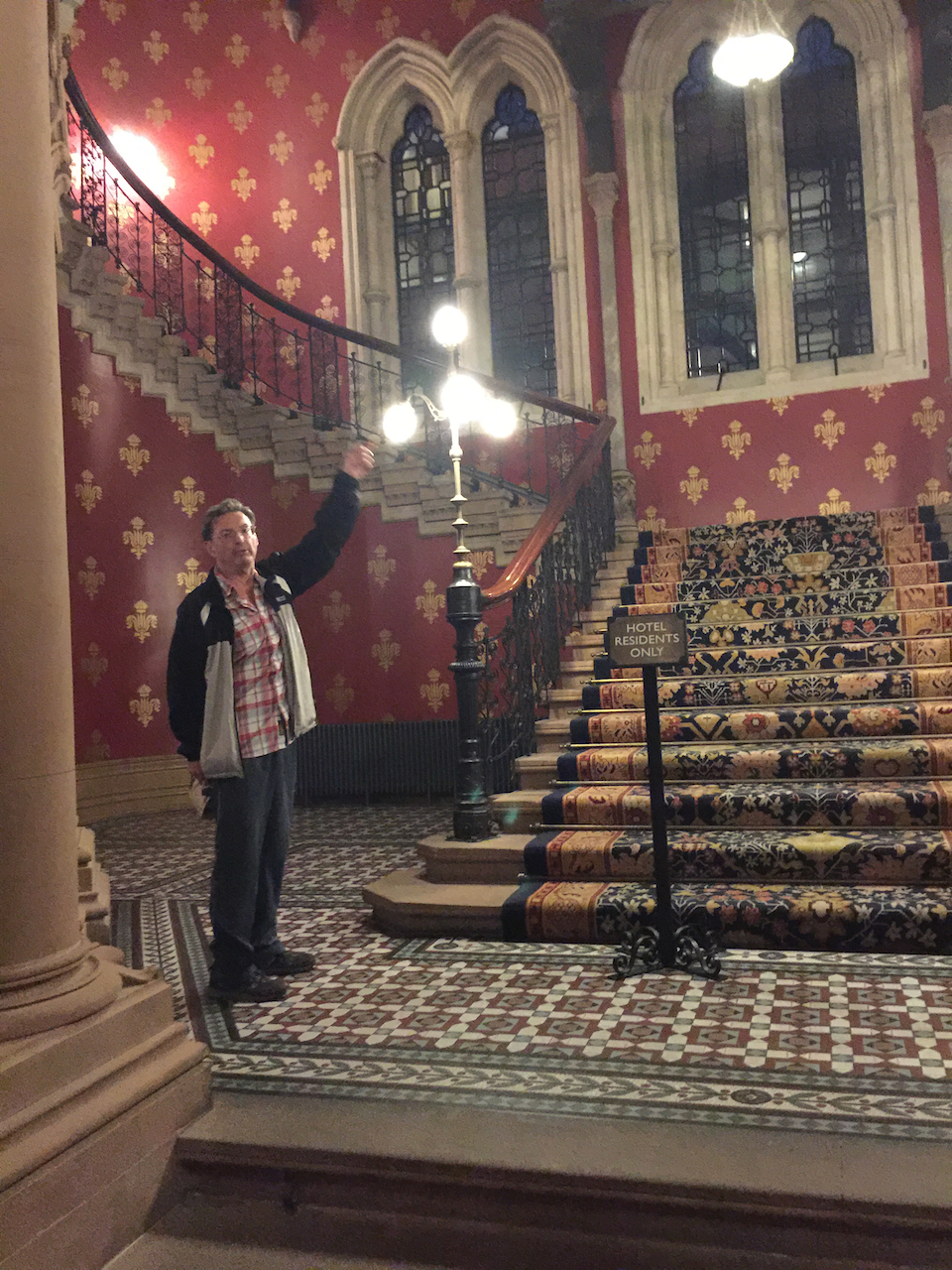 Ron pointing to famous winding staircase in St. Pancras station.